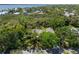 Aerial view of a house surrounded by tropical trees near the bay at 325 12Th W Ave, Palmetto, FL 34221