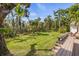 Lush backyard with well-manicured lawn and tropical foliage, creating a serene outdoor space at 325 12Th W Ave, Palmetto, FL 34221