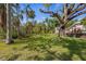 Expansive backyard featuring lush landscaping and mature trees at 325 12Th W Ave, Palmetto, FL 34221
