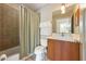 Neutral bathroom featuring a shower-tub combination with curtain, toilet, vanity and sink at 325 12Th W Ave, Palmetto, FL 34221