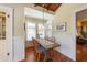 Sun-lit breakfast nook features wood floors, wainscoting and a dining table for four at 325 12Th W Ave, Palmetto, FL 34221