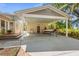 Exterior of house featuring a large carport with boat and grill at 325 12Th W Ave, Palmetto, FL 34221
