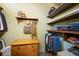 Walk-in closet with wood shelving, wooden dresser and hanging rods for ample storage at 325 12Th W Ave, Palmetto, FL 34221