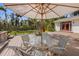 Outdoor deck with table, chairs, and umbrella, perfect for relaxing and entertaining at 325 12Th W Ave, Palmetto, FL 34221