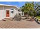 Backyard view showcasing a large wooden deck, outdoor seating and a garden at 325 12Th W Ave, Palmetto, FL 34221