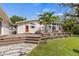 House exterior with deck, lush landscaping, and a stone path at 325 12Th W Ave, Palmetto, FL 34221