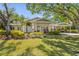 Charming home with well-maintained lawn, lush landscaping, and a welcoming covered front porch at 325 12Th W Ave, Palmetto, FL 34221