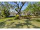 Charming home with mature landscaping and a well-manicured lawn shaded by mature trees at 325 12Th W Ave, Palmetto, FL 34221