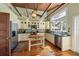 Charming kitchen with white cabinets, tiled backsplash, stainless steel appliances, and wood island at 325 12Th W Ave, Palmetto, FL 34221