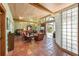 Spacious living room with bed, comfortable seating, terracotta tile floors, and a wall of glass bricks at 325 12Th W Ave, Palmetto, FL 34221