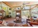 Bright living room offers Saltillo tile floors, exposed wood beams, and many windows at 325 12Th W Ave, Palmetto, FL 34221