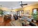 Open-concept living room featuring hardwood floors, natural light, comfortable seating, and dining space at 325 12Th W Ave, Palmetto, FL 34221
