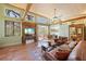Spacious living room features Saltillo tile floors, wooden beams, and large glass doors at 325 12Th W Ave, Palmetto, FL 34221