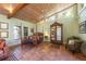 Expansive living room features Saltillo tile floors, bed, and antique armoire at 325 12Th W Ave, Palmetto, FL 34221