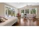 Bright bedroom featuring hardwood floors, a ceiling fan, and access to the outdoors at 325 12Th W Ave, Palmetto, FL 34221