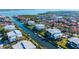 Aerial view of waterfront condos along a canal with lush green landscaping and boat docks at 4104 128Th W St # 704, Cortez, FL 34215
