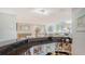 Wet bar featuring stone countertops, wine rack, display shelving, and hardwood floors at 4104 128Th W St # 704, Cortez, FL 34215