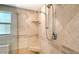 Close up view of bathroom featuring glass shower with dual shower heads, tile flooring, built-in shelf and bench at 4104 128Th W St # 704, Cortez, FL 34215