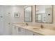 Bright bathroom featuring double sink vanity with modern fixtures, large mirrors, and updated lighting at 4104 128Th W St # 704, Cortez, FL 34215