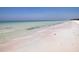 Scenic beach view featuring clear waters, sandy shoreline, and gentle waves in a picturesque setting at 4104 128Th W St # 704, Cortez, FL 34215