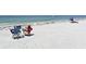 Beach with chairs and people sunbathing, with views of the ocean and a serene beach atmosphere at 4104 128Th W St # 704, Cortez, FL 34215