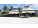 Beach restaurant with outdoor seating, umbrellas, and views of the white sand beach at 4104 128Th W St # 704, Cortez, FL 34215