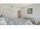 Cozy bedroom with patterned bedding, ample closet space, and a bench at 4104 128Th W St # 704, Cortez, FL 34215