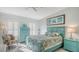 Comfortable bedroom with turquoise furniture, plantation shutters, and stylish decor at 4104 128Th W St # 704, Cortez, FL 34215