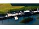 Aerial shot of a private boat dock, featuring waterfront views and covered boat at 4104 128Th W St # 704, Cortez, FL 34215