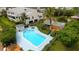 Inviting community pool area with lush landscaping, seating, and a hot tub at 4104 128Th W St # 704, Cortez, FL 34215