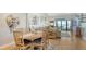 Bright dining room with wood table and seating for six open to the living room at 4104 128Th W St # 704, Cortez, FL 34215