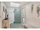 Bright entryway with seahorse wall decor and an inviting blue rug at 4104 128Th W St # 704, Cortez, FL 34215