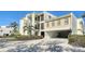 The building features parking and stairs leading to the units above at 4104 128Th W St # 704, Cortez, FL 34215