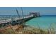 A white fishing pier extends into the turquoise water and provides views of the Gulf at 4104 128Th W St # 704, Cortez, FL 34215