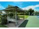 Charming wooden gazebo located near the community tennis court at 4104 128Th W St # 704, Cortez, FL 34215