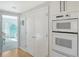 Bright kitchen features white cabinetry, stainless steel appliances, and hardwood floors at 4104 128Th W St # 704, Cortez, FL 34215