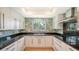 Modern kitchen with granite countertops and stainless steel appliances at 4104 128Th W St # 704, Cortez, FL 34215