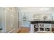 Kitchen featuring white cabinets, stainless steel appliances, wine rack and hardwood floors at 4104 128Th W St # 704, Cortez, FL 34215