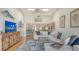 Bright and airy living room with a large sectional sofa and seamless flow to the kitchen at 4104 128Th W St # 704, Cortez, FL 34215