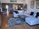 Spacious living room featuring a sectional sofa, hardwood floors, and stylish decor with shelfing units at 4104 128Th W St # 704, Cortez, FL 34215