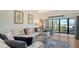 Comfortable living room with a large sectional sofa and sliding glass doors to a waterfront balcony view at 4104 128Th W St # 704, Cortez, FL 34215