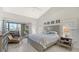 Well-lit main bedroom with vaulted ceiling, neutral paint, and sliding glass door to private patio at 4104 128Th W St # 704, Cortez, FL 34215