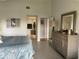 Well-lit bedroom featuring a dresser with a mirror, and access to an en-suite bathroom at 4104 128Th W St # 704, Cortez, FL 34215