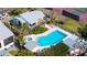 Aerial view of the community pool with surrounding lush landscaping and lounging areas at 4104 128Th W St # 704, Cortez, FL 34215