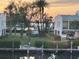 Waterfront property with palm trees and neighborhood views during sunset at 4104 128Th W St # 704, Cortez, FL 34215