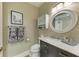 Well-lit bathroom with a stylish vanity and a framed round mirror at 4110 Central Sarasota Pkwy # 123, Sarasota, FL 34238