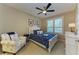 Comfortable bedroom with a ceiling fan, plantation shutters, and charming decor at 4110 Central Sarasota Pkwy # 123, Sarasota, FL 34238