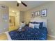 Well-lit bedroom with comfy bed, nautical decor and sitting chair with an en suite bathroom at 4110 Central Sarasota Pkwy # 123, Sarasota, FL 34238