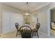 Cozy dining area featuring a round table and modern light fixture at 4110 Central Sarasota Pkwy # 123, Sarasota, FL 34238