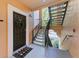 Condo entryway with a welcome mat and exterior staircase at 4110 Central Sarasota Pkwy # 123, Sarasota, FL 34238
